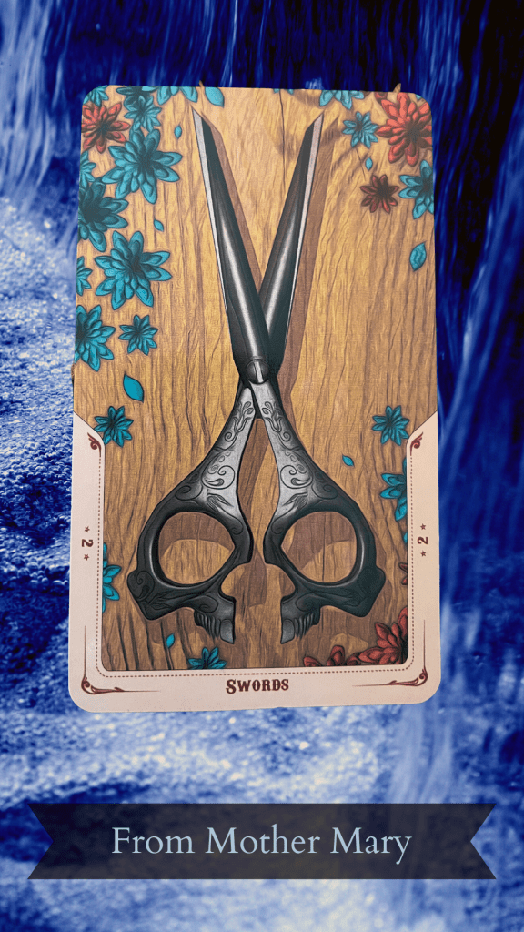 Two of Swords tarot card reversed, depciting an ornate set of scissors against a wooden table with blue and orange flowers int he corners. All set against a background of blue, flowing water.